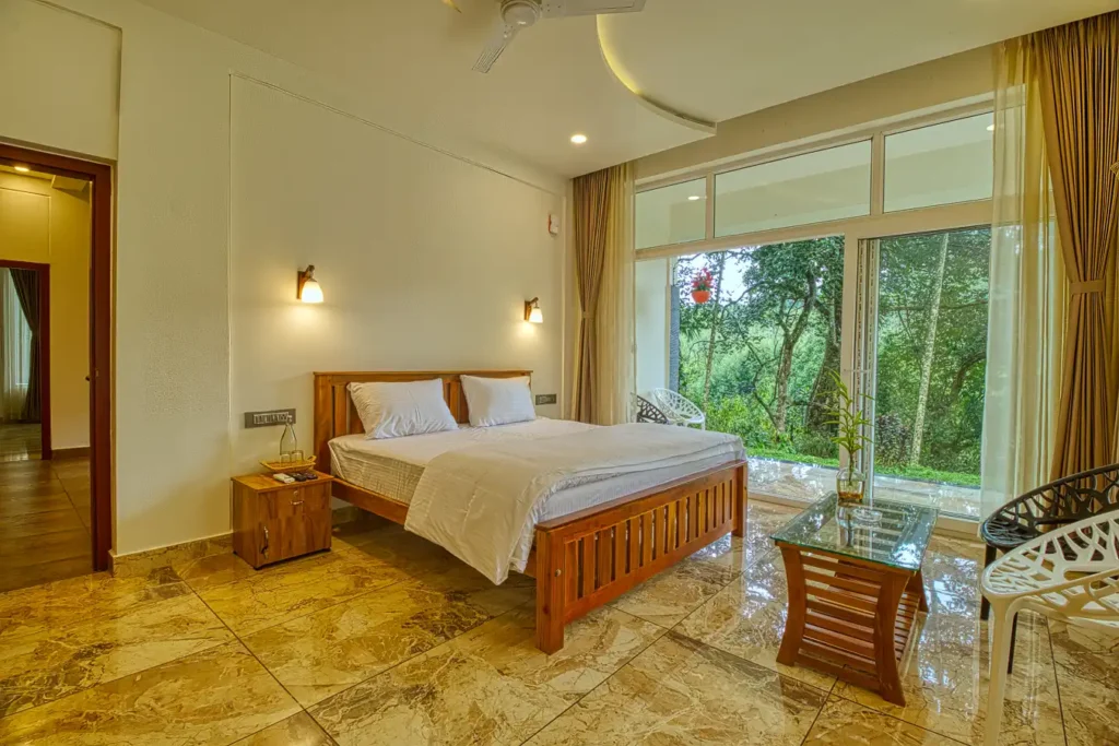 Spacious suite room with king-size bed and forest view at Ende Wayanad Resort, Wayanad